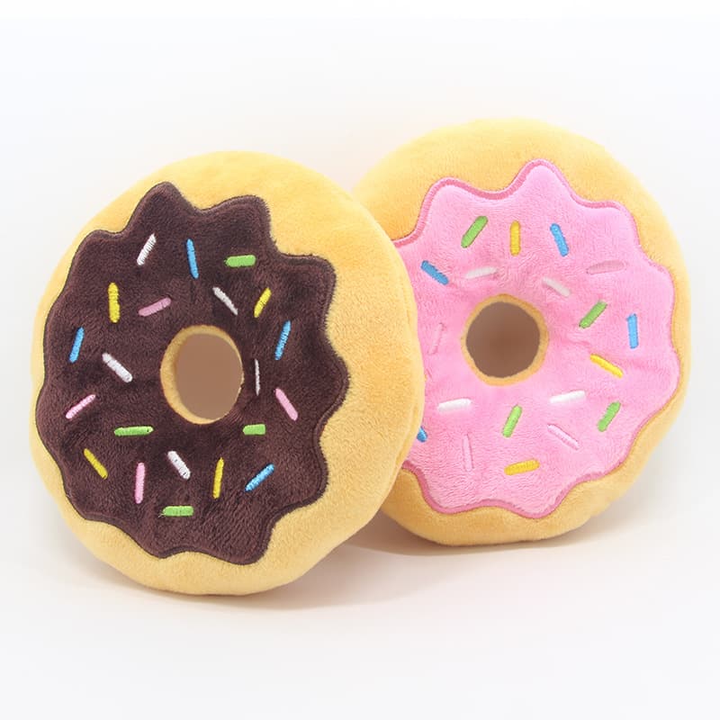 Chocolate and Strawberry Squeaky Donut Plush Toys placed on an empty background