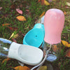 Pink, Turquoise and White Travel Water Bottles placed on grass