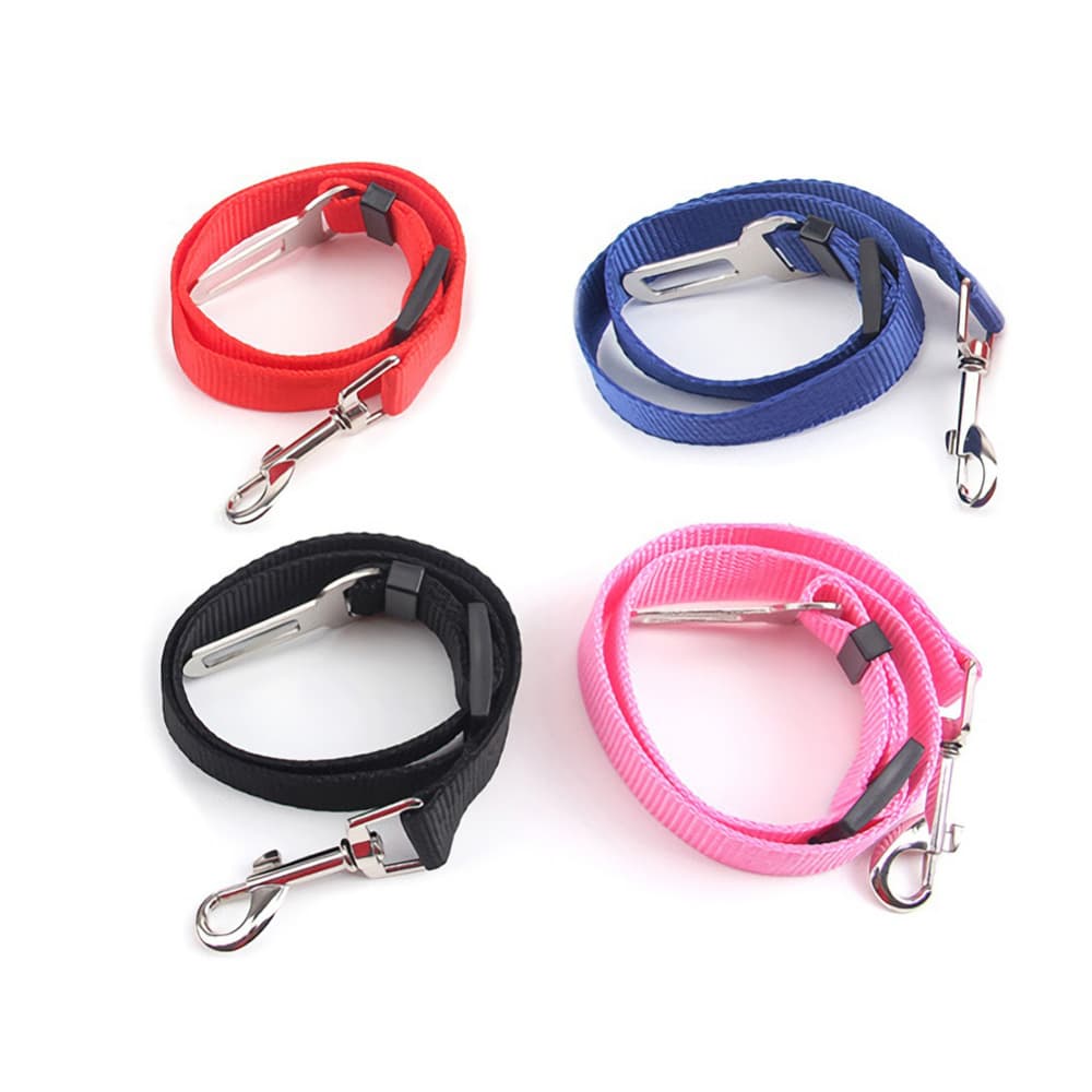 Red, Blue, Black and Pink Dog Car Seat Belts in front of a blank background