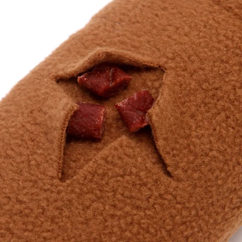 Pieces of meat placed in a hole of the Snail Snuffle Mat